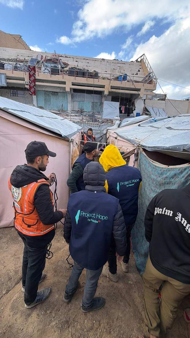 Project Hope and Civil Defense crews reinforcing shelter together.