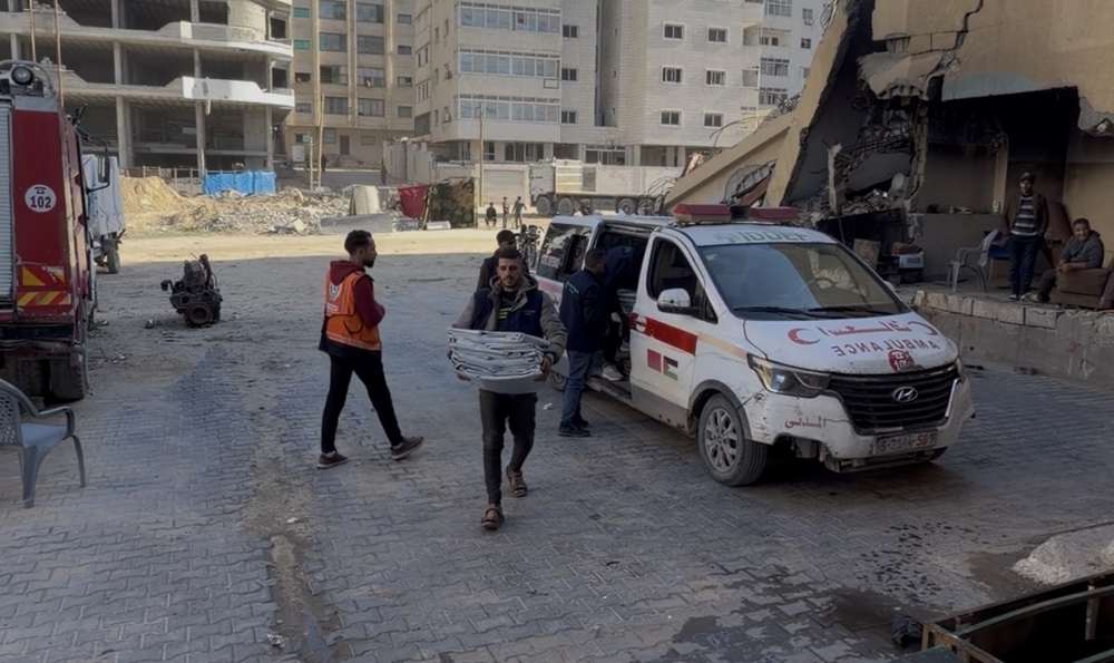 Civil Defense crews and Project Hope volunteers beside an ambulance