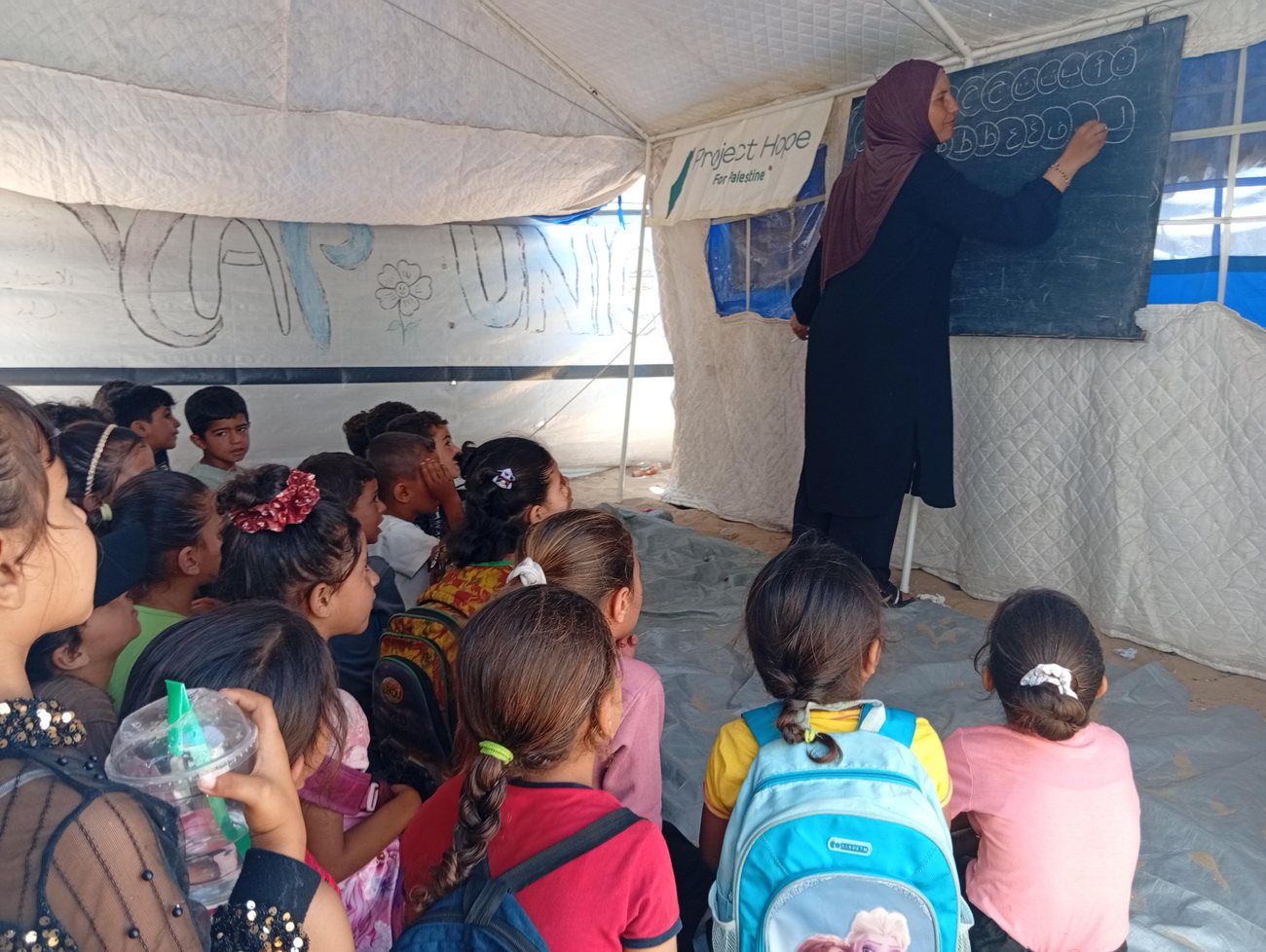 A tent classroom we equipped, mid-lesson.